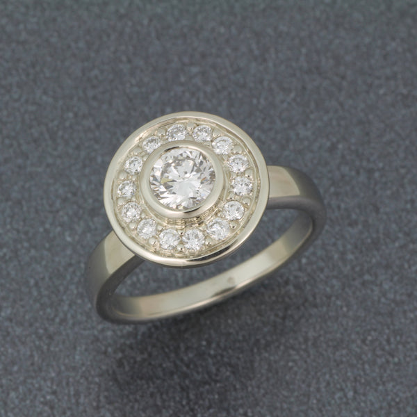 Diamond halo pedestal ring